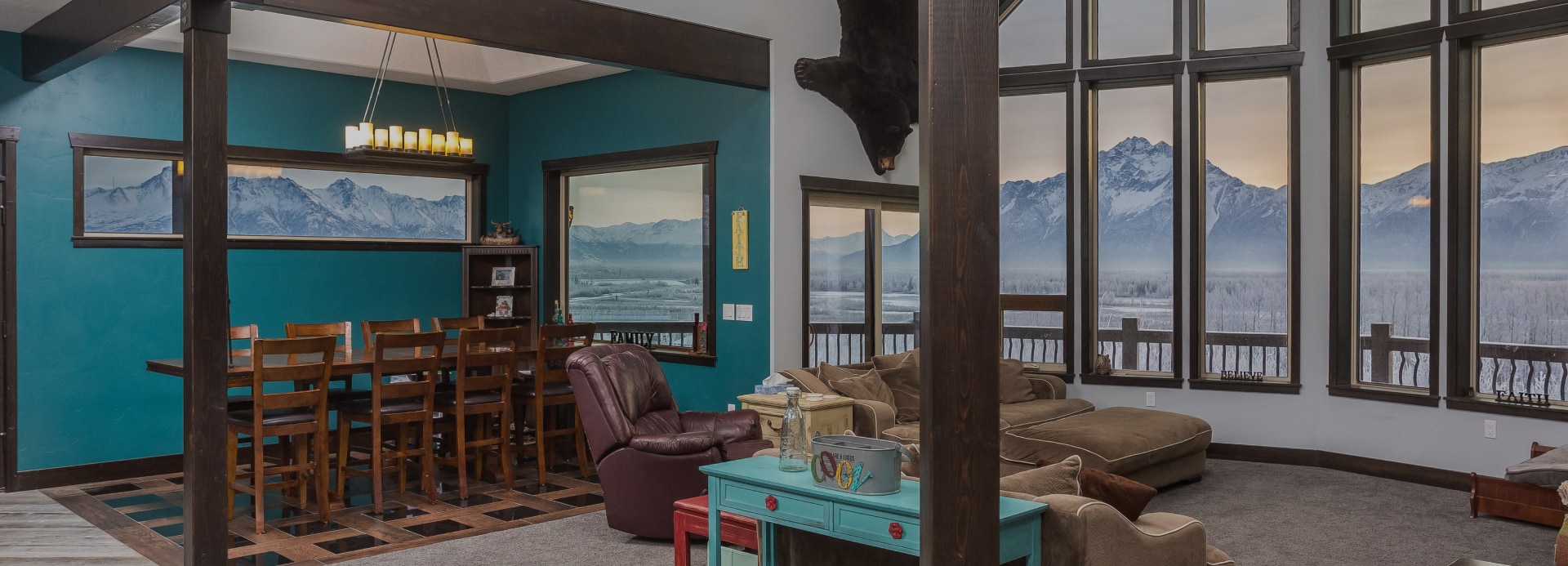 Custom home featuring large windows with scenic mountain view in Palmer Alaska