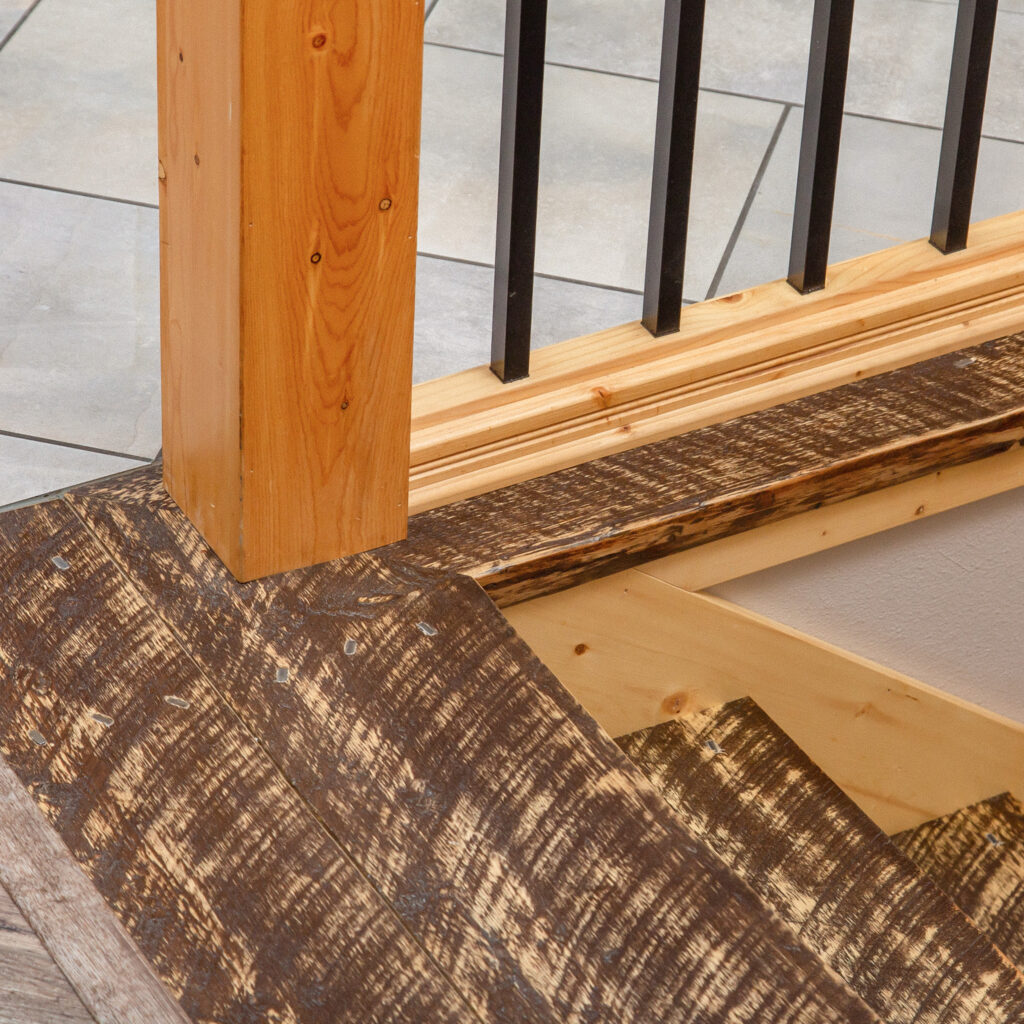 Final steps of textured wood stairs leading to another floor