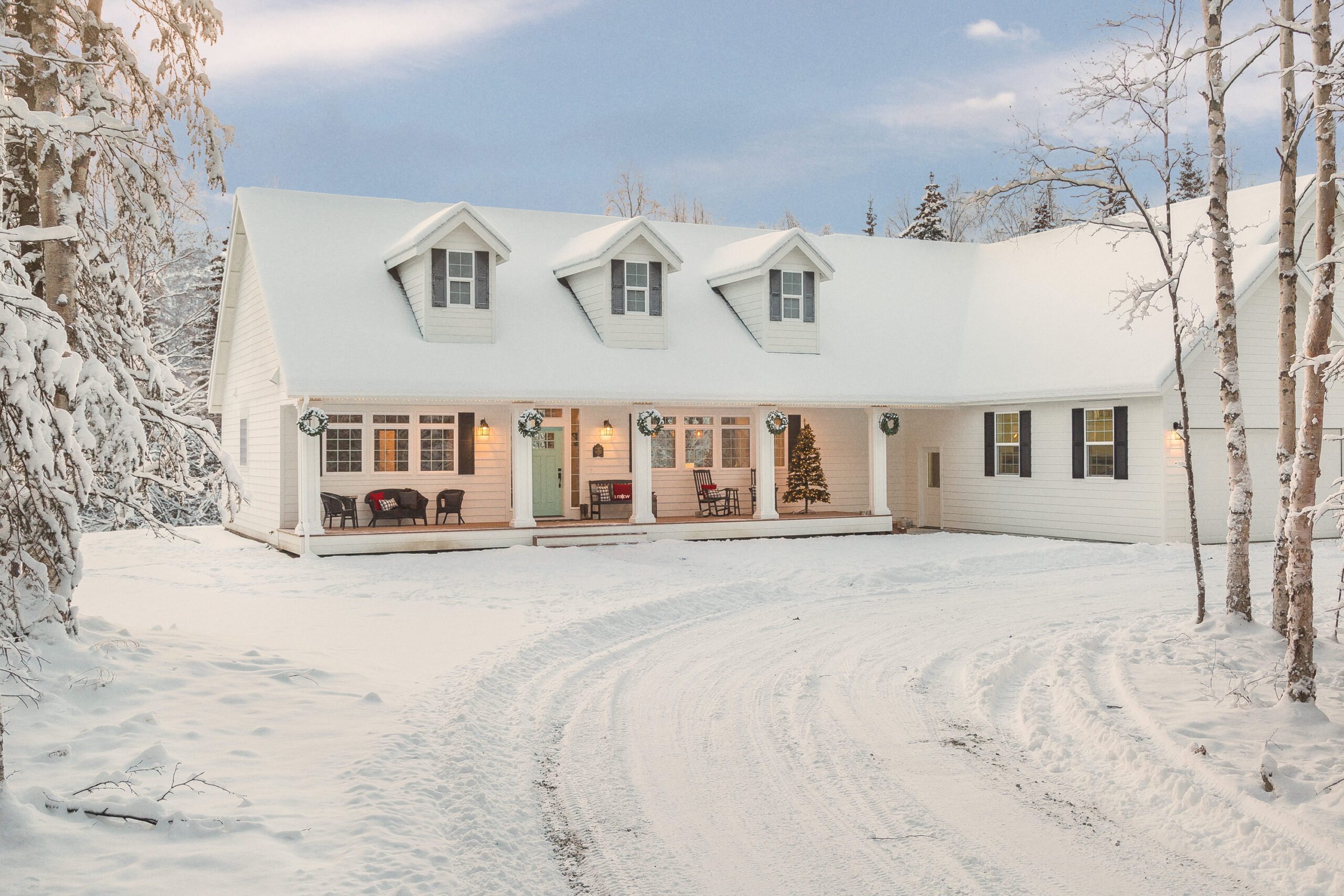 White house with long front porch in the snow