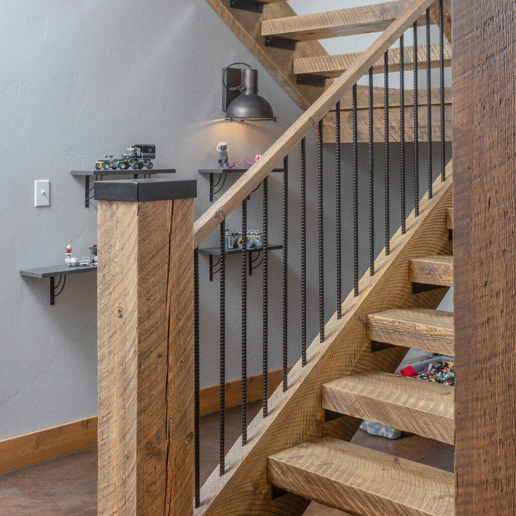Hallway leading past exposed wooden stairs in a house