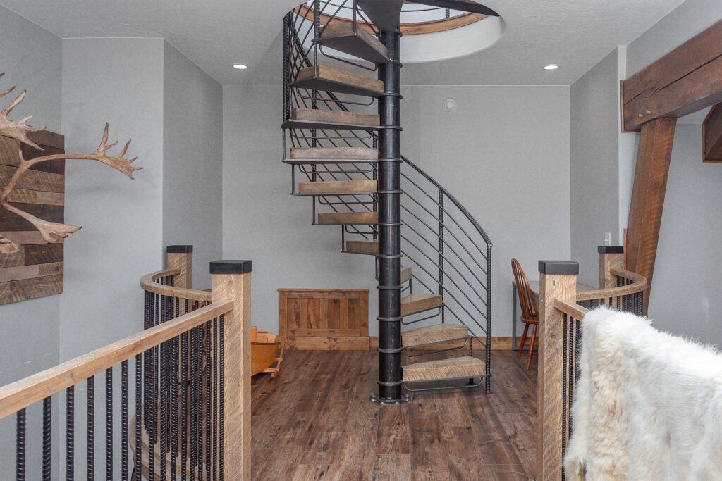 Spiral staircase of wood boards and metail railings in a house