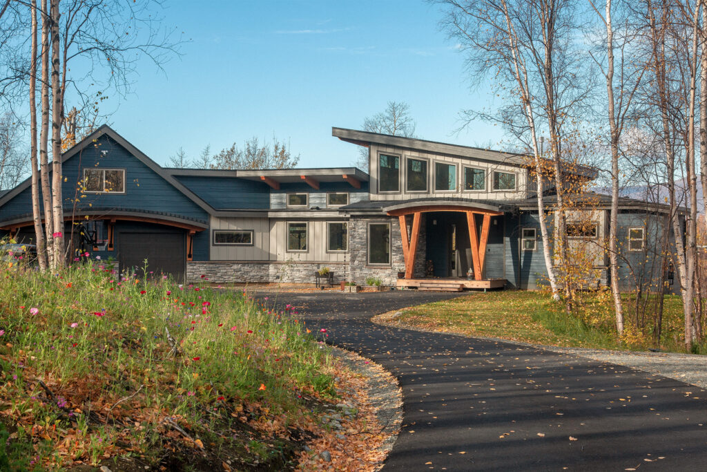 Driveway leading to newly built modern custom home in Alaska
