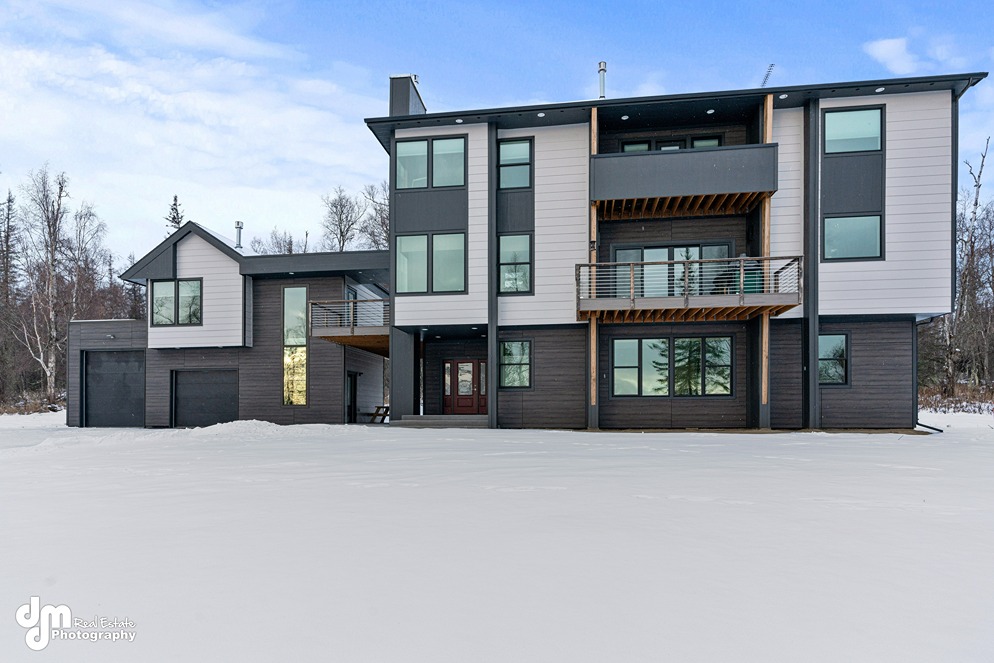 Modern custom home built in Alaska with snow on the ground