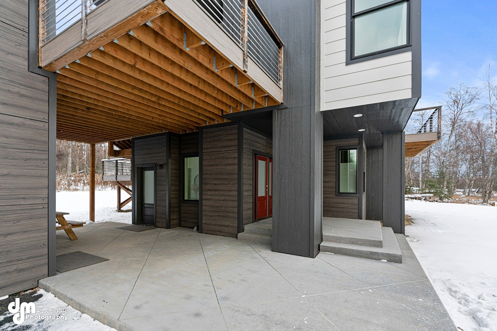 Concrete patio outside of modern custom built home in Alaska