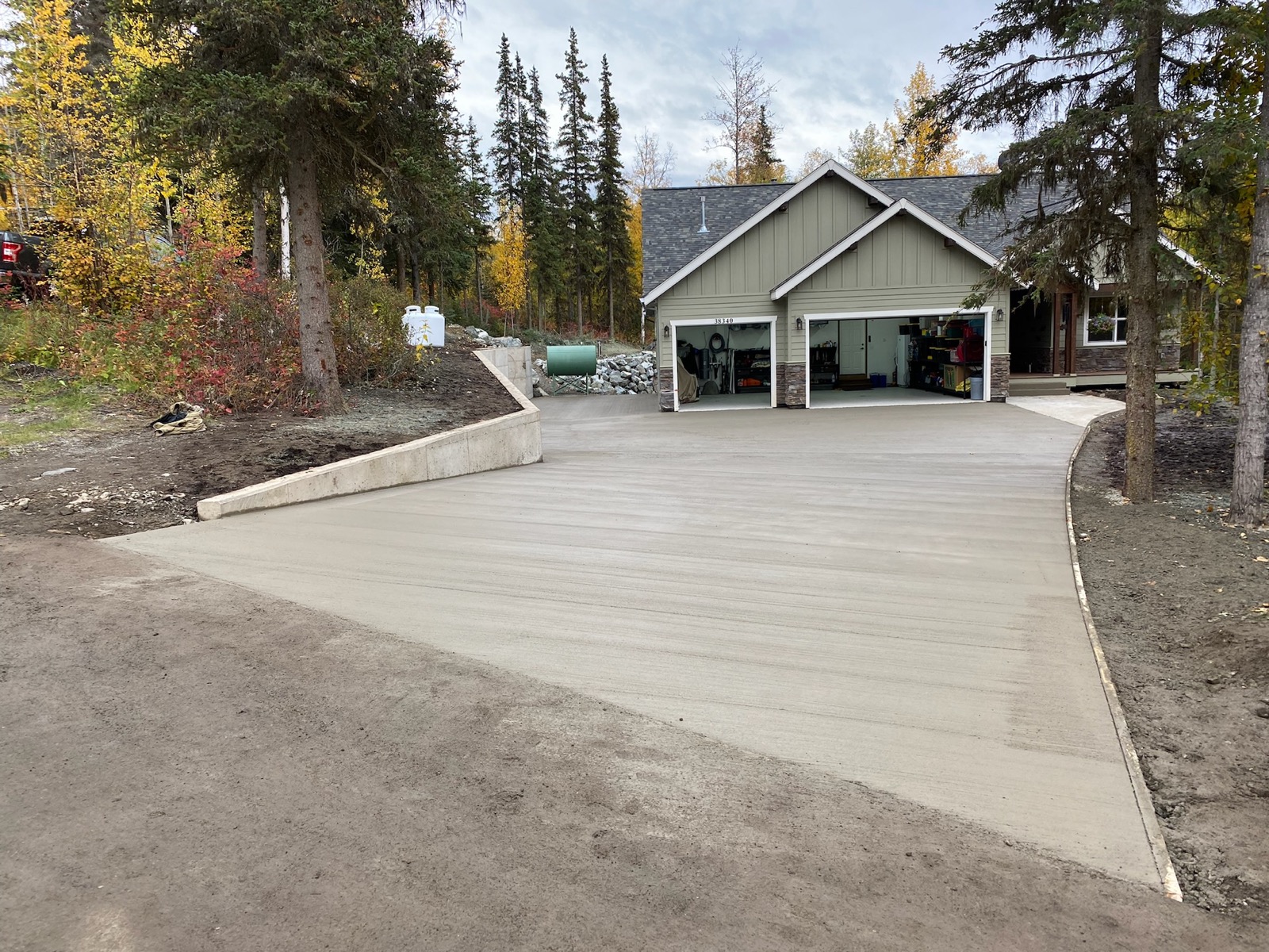 Newly laid concrete driveway leading to house's garage