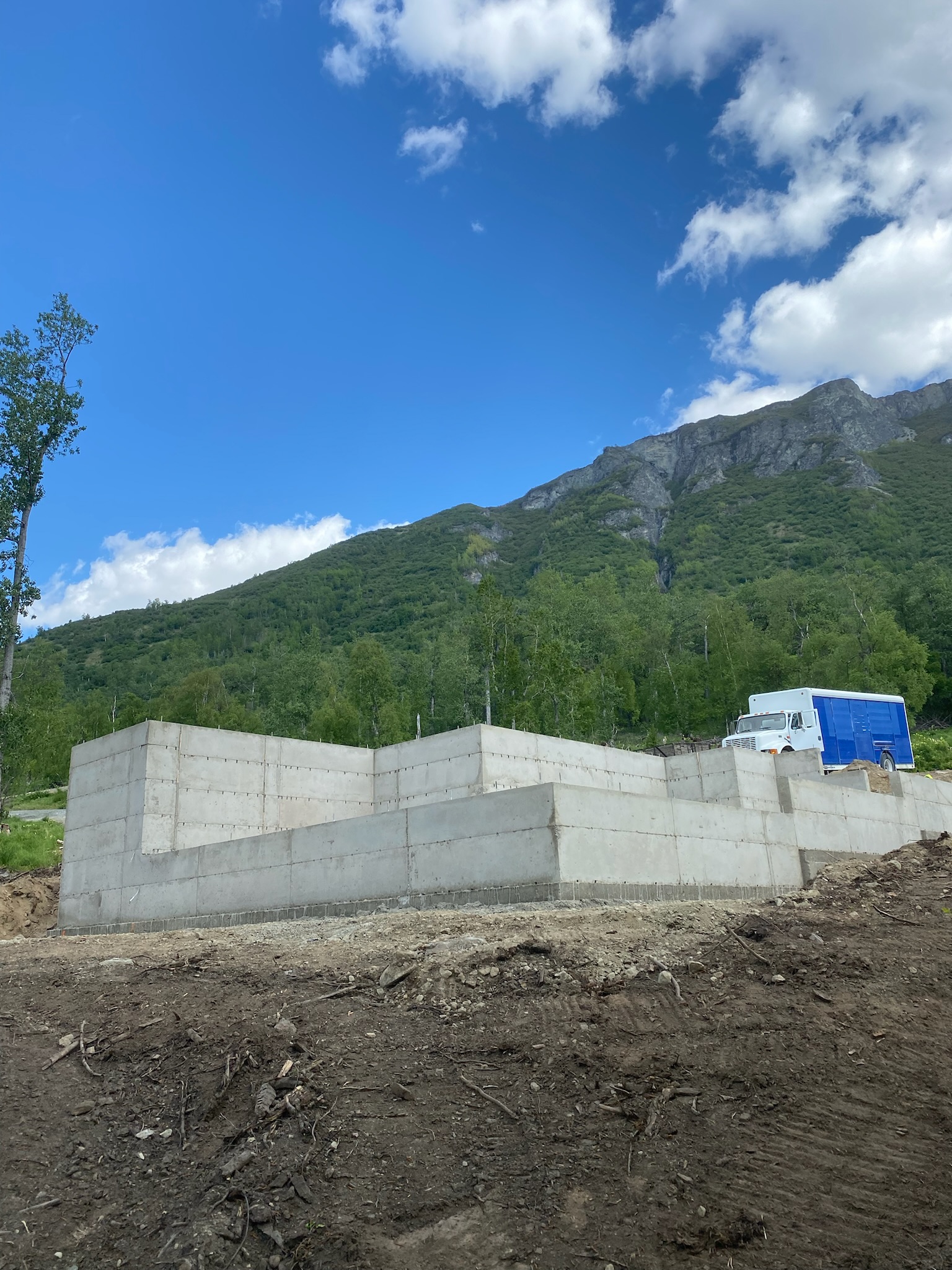 Concrete foundation with truck in the background