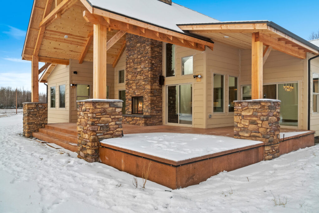 Custom built home in Alaska featuring large back deck & outdoor fireplace
