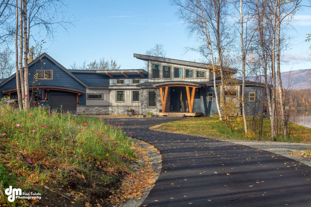 Driveway leading to a modern custom built home in Alaska