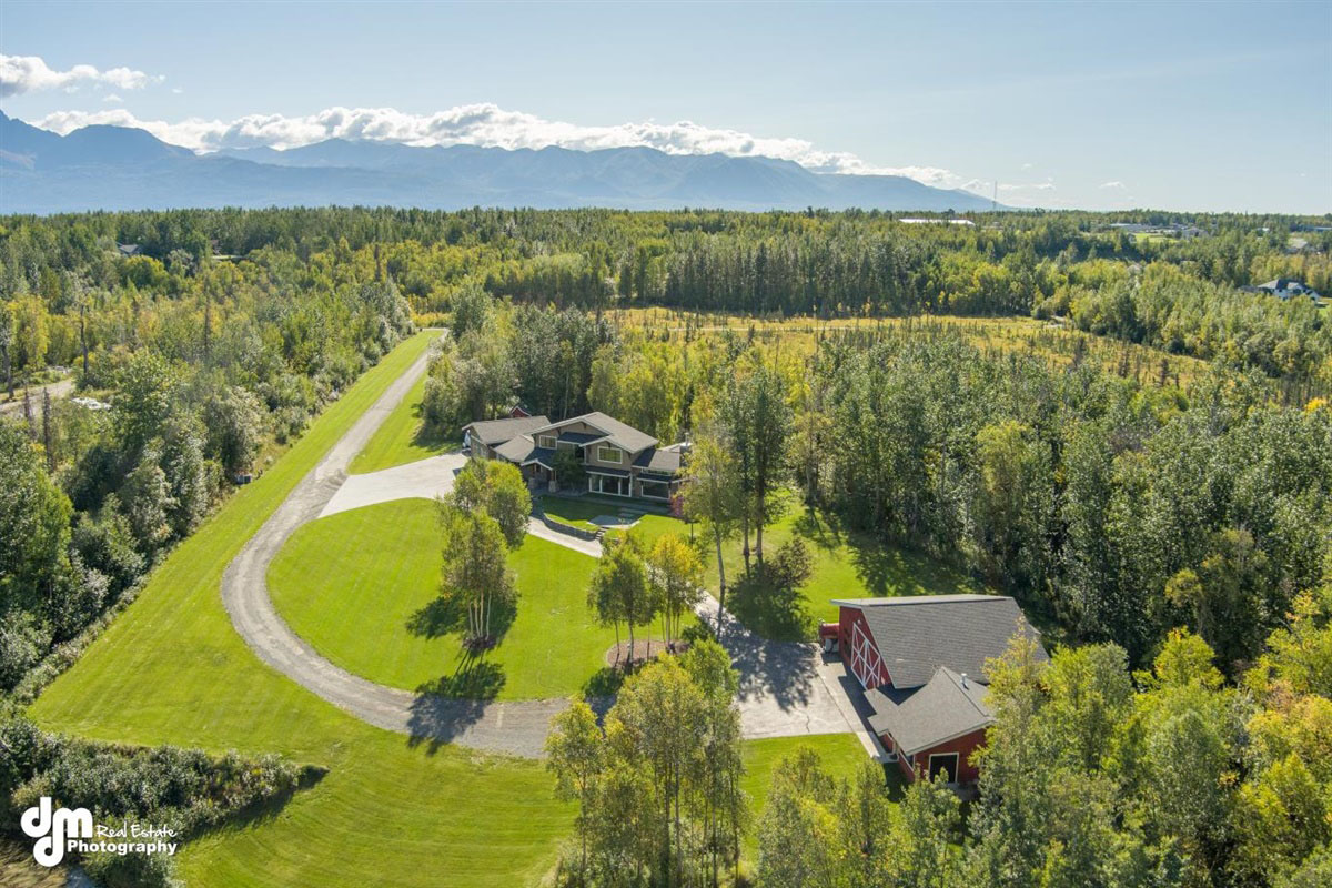 Overhead view of custom built home in Alaska with mountains in background