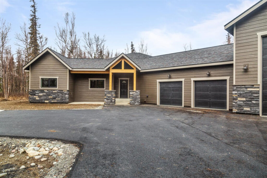 Custom home built in Alaska with 3-door garage and newly laid driveway