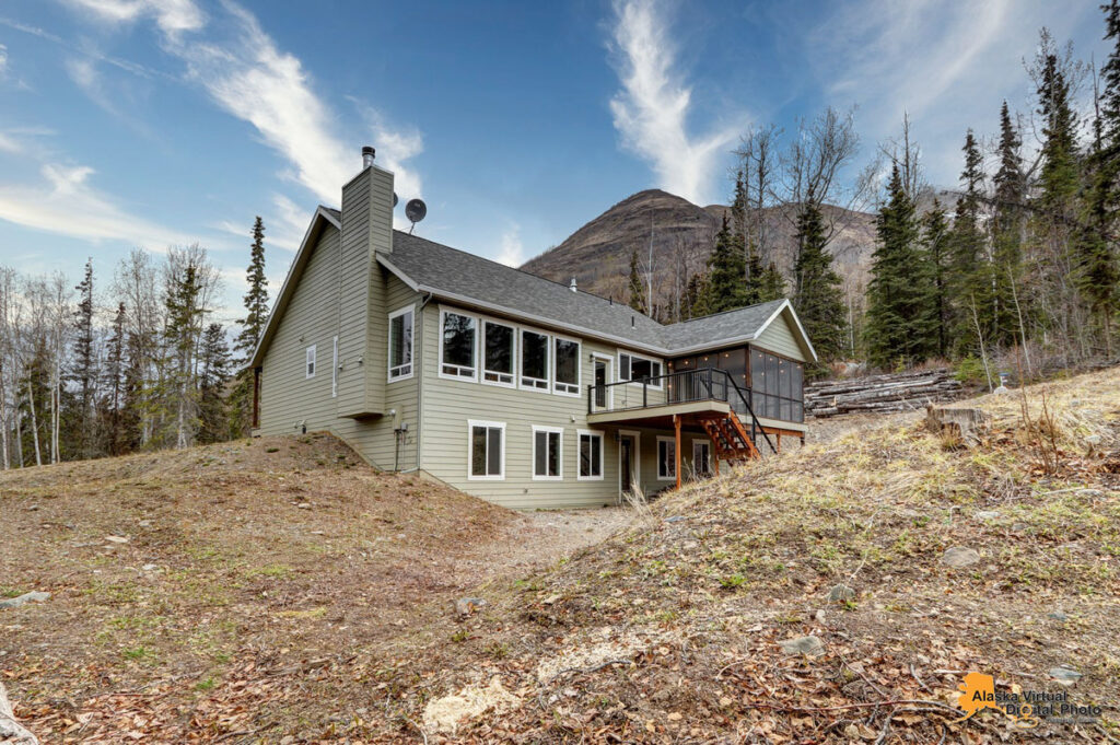Custom built single-family home in Alaska featuring screened in porch