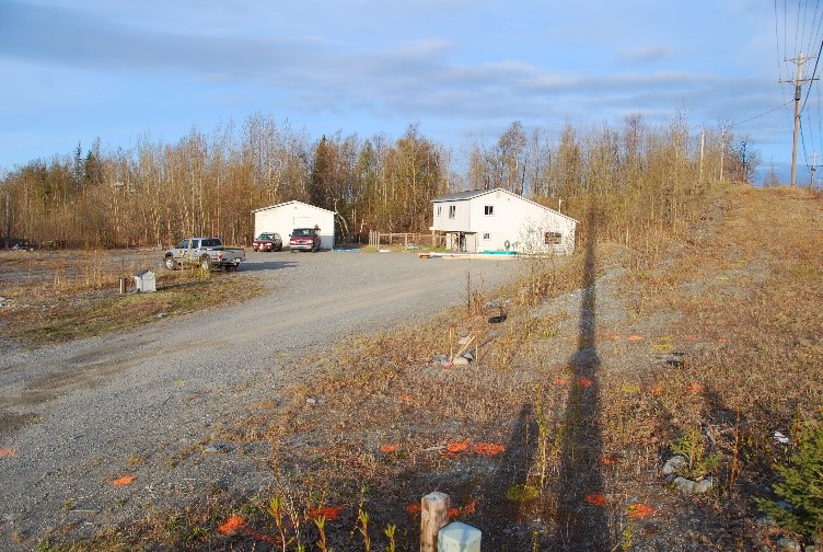 Long driveway with home in the background