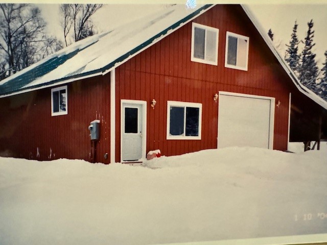 Red barn covered in snow